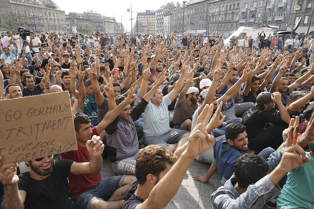 "Syrian refugees strike in front of Budapest Keleti railway station. Refugee crisis. Budapest, Hungary, Central Europe, 3 September 2015" by Mstyslav Chernov - Own work. Licensed under CC BY-SA 4.0 via Wikimedia Commons - https://commons.wikimedia.org/wiki/File:Syrian_refugees_strike_in_front_of_Budapest_Keleti_railway_station._Refugee_crisis._Budapest,_Hungary,_Central_Europe,_3_September_2015.jpg#/media/File:Syrian_refugees_strike_in_front_of_Budapest_Keleti_railway_station._Refugee_crisis._Budapest,_Hungary,_Central_Europe,_3_September_2015.jpg